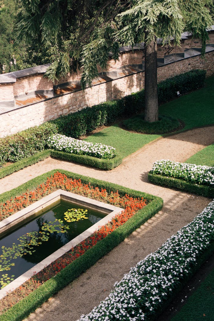 Beautiful garden at Topkapı Palace in Istanbul with vibrant flowers and tranquil pond.